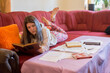 © Solid photos - Young serious woman student studying for exams at home