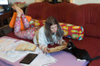 © Solid photos - Young serious woman student studying for exams at home