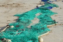 Closeup Of Colorful Fishing Nets On The Beach Under The Sunlight