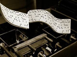 Grayscale shot of an old punch card machine