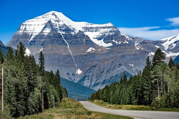 Sticker - Snow-capped peaks of Robson Mountain under a blue sky in Canada.