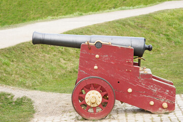 Old historic cannon at Kastellet in Copenhagen in Denmark with green grass in the background