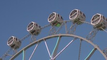 View Of The Highest Part Of The Gigantic Panoramic Wheel, The White Cabins With Colored Lights Roll Slowly