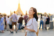 © Jirawatfoto - Portrait young beautiful asian woman smiling while travel at Wat Arun sunset view point, Bangkok, Thailand.