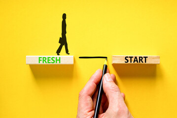 Wall Mural - Fresh start and motivational symbol. Concept words Fresh start on wooden block. Beautiful yellow table yellow background. Businessman hand. Business motivational and Fresh start concept. Copy space.