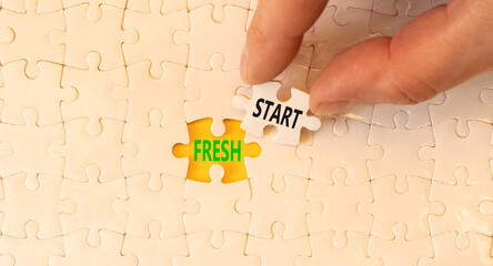 Wall Mural - Fresh start and motivational symbol. Concept words Fresh start on white puzzles. Beautiful yellow table yellow background. Businessman hand. Business motivational and Fresh start concept. Copy space.