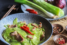 Fresh Vegetable Celtuce (stem Lettuce, Lactuca Sativa Var Augustana ) Stir Fried With Some Meat And Spices On Table - Chinese Cuisine