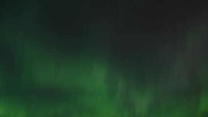 Wall Mural - Green light of Aurora Borealis cover the night sky. Time lapse. 