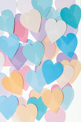 Sticker - many colored paper hearts on a light background