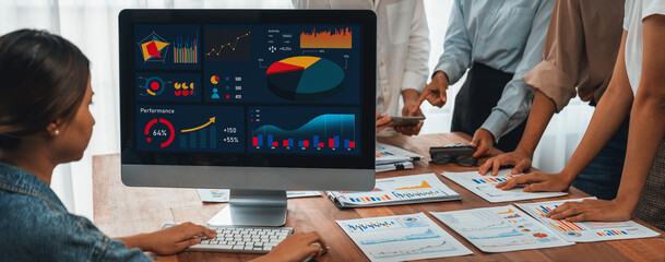 Leinwandbilder - Panorama shot analyst team utilizing BI Fintech to analyze financial report with laptop. Businesspeople analyzing BI power dashboard displayed on laptop screen for business insight. Scrutinize