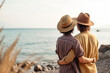 © Nedrofly - A couple of people gay standing on top of a beach