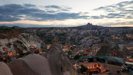 Wall Mural - Panoramic panning of Goreme, Turkey. Goreme is known for its fairy chimneys eroded rock formations many of which were hollowed out in the Middle Ages to create houses churches and underground cities.