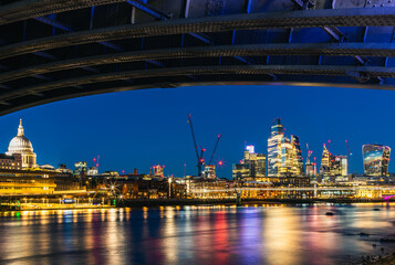 View of St. Pauls Cathedral and Skyscrapers from under Blackfriars Bridge, River Thames, London, England