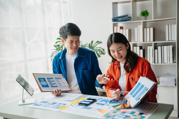  UX developer and ui designer brainstorming about mobile app interface wireframe design with customer breif and color code at office...