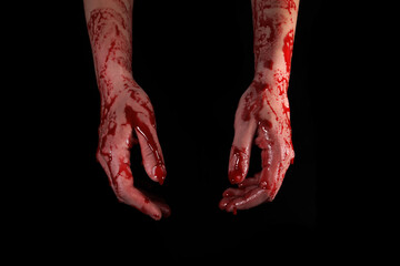 Fototapeta bloody hands on a black background, the concept of self-defense, murder, nightmares, halloween