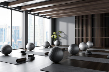 Gray and wooden yoga studio corner with mats and fitballs