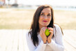 © luismolinero - Middle aged woman holding an apple