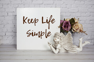 Wall Mural - inspirational quote keep life simple text message written on white wooden board