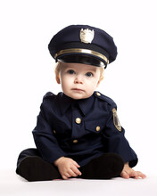 Cute Toddler Wearing Police Officer Uniform. Isolated On White Background