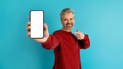 Happy middle aged man showing great mobile app, mockup
