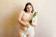 Smiling plus size woman in beautiful flower underwear
