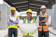 © Supachai - Group Indian construction team engineer wear vest and helmet safety and female leader hold blueprint standing together at factory construction site for making precast concrete wall.