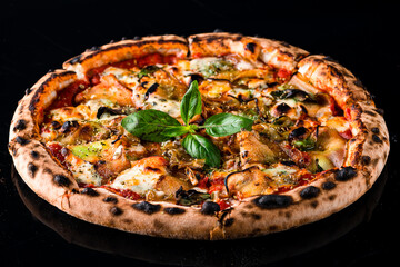 Wall Mural - Vegetarian pizza with eggplant, cheese, tomatoes, basil, tomato sauce and spices on black.