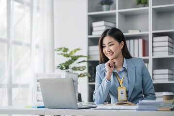 Wall Mural - Business woman using calculator for do math finance on wooden desk in office and business working background, tax, accounting, statistics and analytic research concept..