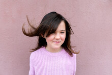 Cute Child In Sweater Standing With Flying Hair