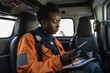 © wetzkaz - Black African American EMS Professional Paramedic on the Way to Hospital. Generative AI