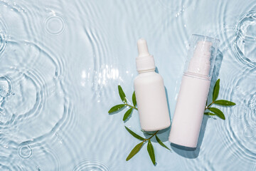 White bottle flacon cosmetics beauty product in water drop