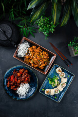 Poster - Asian set of chicken with onion, celery, cashew nuts, pork in Thai sweet chili sauce and sushi roll set with shrimps tempura, cucumber, onion.