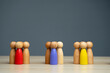 Groups of multicolored wooden people on a gray background. The concept of market segmentation. Target audience, customer care. Market group of buyers. Customer relationship management. Selective focus