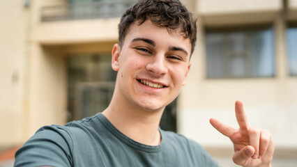 Wall Mural - portrait of young Caucasian man teenager 18 or 19 years old outdoor