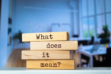 Wooden blocks with words 'What does it mean?'.
