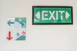 Fire and flood exit sign in the corridor of the building with arrow pointing to safe place direction. Warning notifications that are often found in mall, hospital, school, campus, office, hotel.