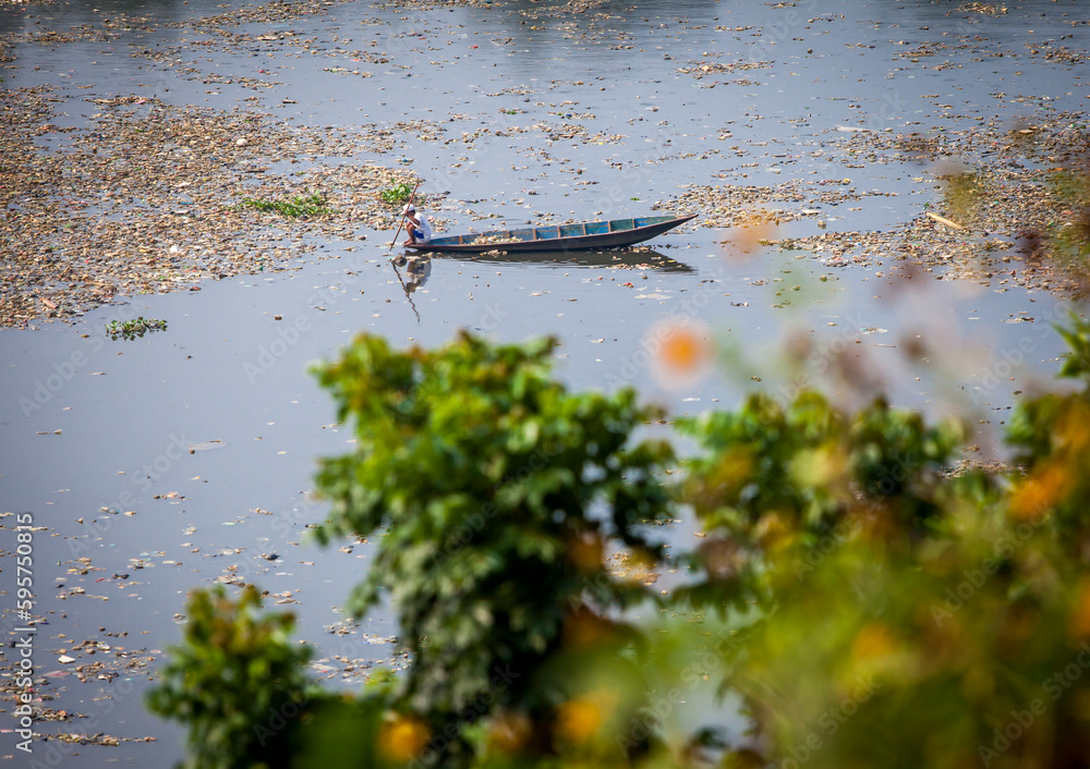 Java River Pollution People collect trash that can be recycled and traded from the sea of ...