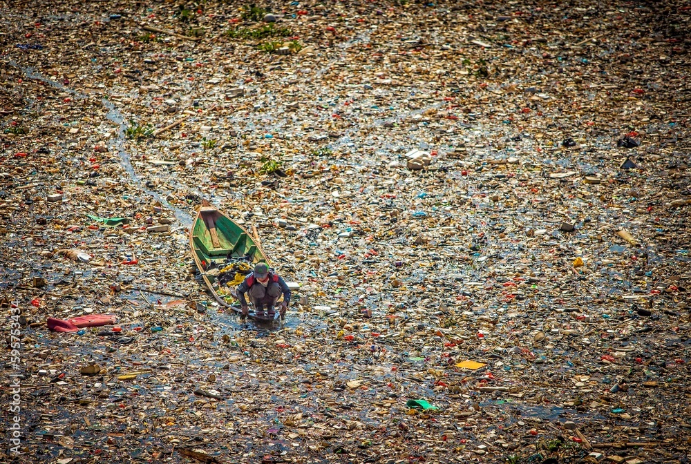 Java River Pollution People collect trash that can be recycled and traded from the sea of ...