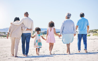 Canvas Print - Holding hands, back and big family at the beach for holiday, walking and summer weekend by the ocean. Affection, support and parents, children and grandparents on a walk by the seaside for bonding