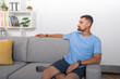 © Guillermo Spelucin - Young man sitting on the sofa