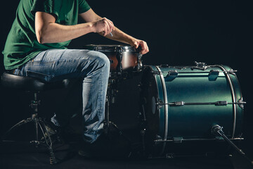 Wall Mural - A man is a drummer and a drum set, the musician is preparing to play.