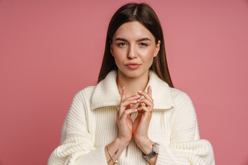 Wall Mural - Woman clasping hands isolated over pink background