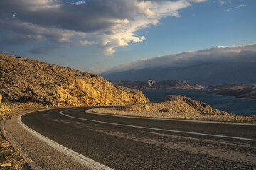 Wall Mural - An asphalt road running past a beautiful viewpoint on the Island of Pag,Croatia.