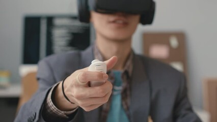 closeup of young asian software engineer pressing button on controller while experiencing with virtu