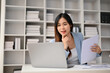 © bongkarn - Smart Asian businesswoman preparing reports and working on her business project on her laptop