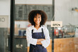 © Nuttapong punna - Startup successful small business owner sme African woman stand with tablet  in cafe restaurant. woman barista cafe owner. .