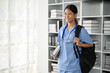 © bongkarn - Young Asian medical student smiling and standing in the study room.