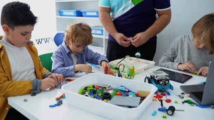 Wall Mural - robotics programming class. children construct and code robot. stem education using constructor bloc