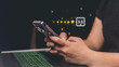 © Sunisa - Customer review concept. Businessman using smartphone with 5 stars rating icon.