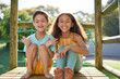© Caia Image - Portrait happy sister and brother with Down Syndrome at playground